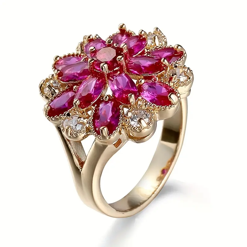 Goldring mit pinker Blume und Kristallen